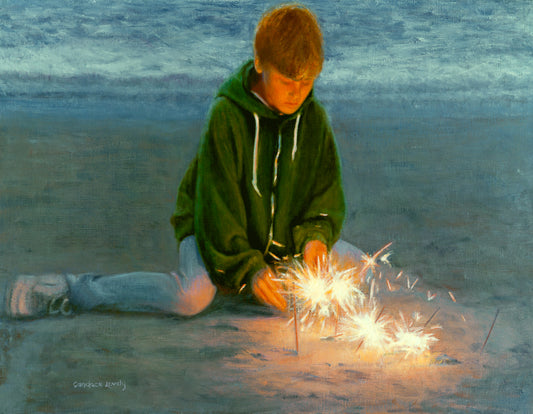 Boy at the beach with sparklers 